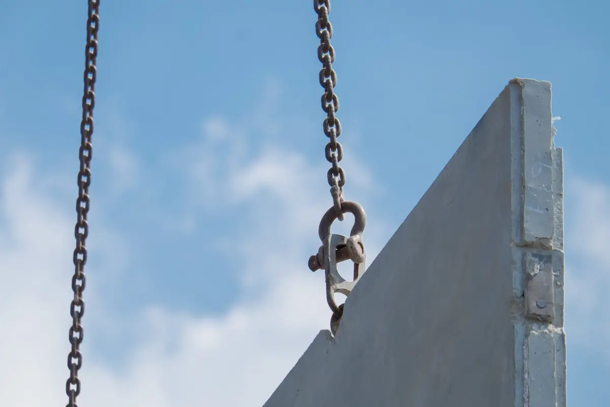 Mobile crane lifting a precast concrete unit on a UK construction site — a crane lifting operation carried out to an approved lift plan