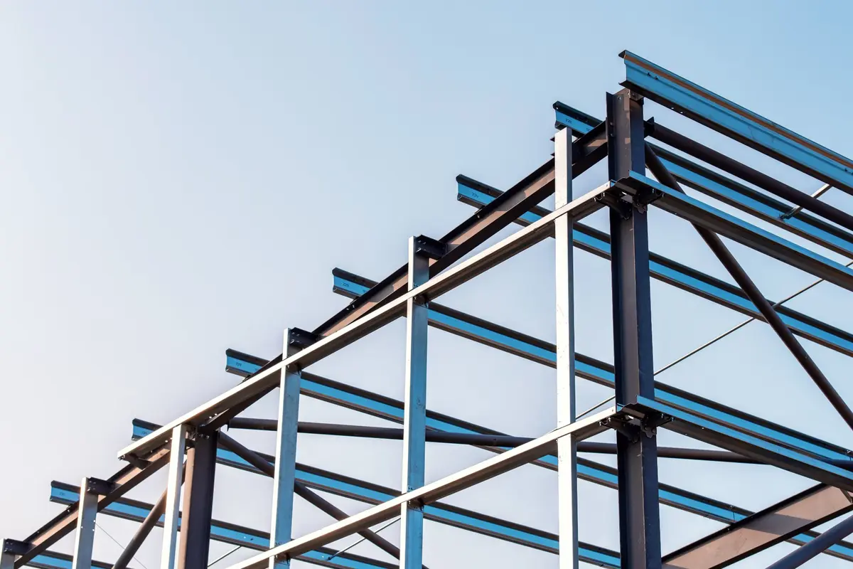 Steel erection lifting operations inside a UK warehouse project — the kind of site work that requires an Appointed Person to plan the lifts